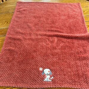 Little Joy baby blanket with embroidered dog. Rust color nubby fabric.